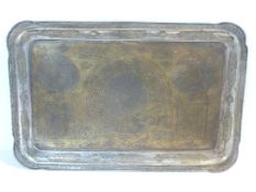 A large Islamic rectangular brass and white metal tray engraved and inlaid, decorated with script