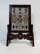 A Qing dynasty Chinese carved and pierced hardwood table screen and geometric stand. The screen is