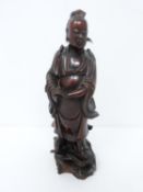 A Qing dynasty carved wooden immortal on stand with hair detailng to the ears. H25cm