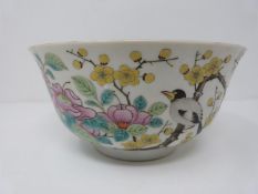 A Guangzhou period Chinese porcelain footed bowl decorated with song birds and yellow prunus blossom