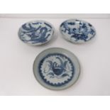 Three 18th to 19th century provincial blue and white footed dishes decorated with dragons and