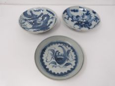 Three 18th to 19th century provincial blue and white footed dishes decorated with dragons and