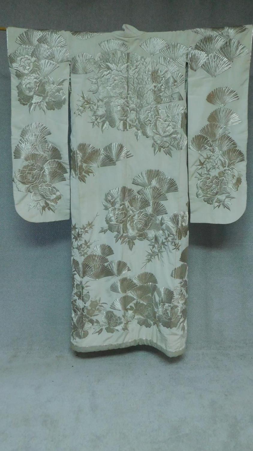 A Japanese cream silk metallic embroidered kimono, decorated with flowers, fans and pagodas. - Image 2 of 6