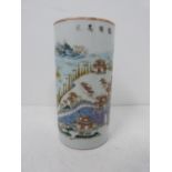 A Famille Rose style cylindrical vase/brush pot with landscape decoration and Chinese characters.