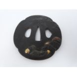 A 19th century Shibuchi bronze Tsuba with gilded details. It depicts on one side a rock with a fence
