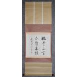 A Japanese mounted scroll, ink on paper, calligraphy within a floral silk border, signed. L.116x42cm