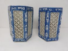 A pair of Late Qing dynasty Chinese blue ground pierced hexagonal porcelain lanterns decorated