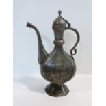 A 19th century Indo-Persian white metal inlaid and engraved hinged lid ewer depicting animals