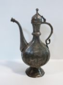 A 19th century Indo-Persian white metal inlaid and engraved hinged lid ewer depicting animals