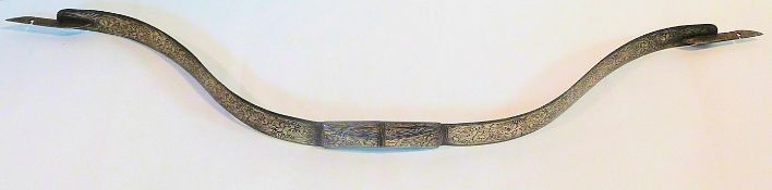 An Indian 19th century Koftaghari metal bow inlaid with a white metal floral and scrolling design.