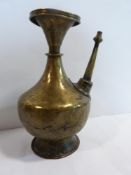 An 18th century Indian brass ewer with decoration around the spout. h27cm