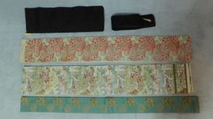 Five Japanese embroidered silk and fabric Obis with various floral designs, two decorated with