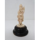 A 19th century ivory carved statue of Ganesha the Indian god mounted on a circular ebonised base.
