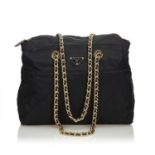 A Prada Tessuto Black Gold, gives you a sporty chic style. In quilted nylon it features gold chain