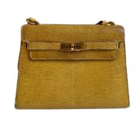 A yellow Hermes Kelly in Lizard with gold hardware, including strap. W.20cm x H.14cm x D.9cm,