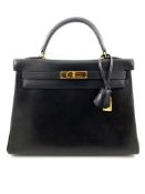 A black Hermes Kelly in box leather with gold hardware, includes Dustbag, Lock, Clochette & Strap.