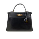 A black Hermes Kelly in box leather with gold hardware, includes Dustbag, Lock, Clochette & Strap.