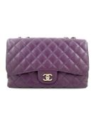 A Chanel Classic Flap Bag Jumbo in Purple Caviar with Silver Hardware, is instantly recognizable