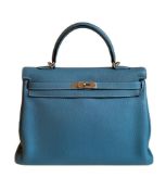 A blue jean Hermes Kelly in clemence leather with palladium hardware, includes Dustbag, Lock,