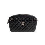 A Chanel Classic Camera Case in Black Lambskin with Silver Hardware, takes design inspiration from