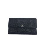 A Chanel Camelia Wallet in Black Calfskin with Silver Hardware, with the Chanel logo in silver.