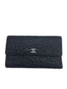 A Chanel Camelia Wallet in Black Calfskin with Silver Hardware, with the Chanel logo in silver.