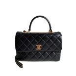 A Chanel Trendy CC in Black quilted leather with Gold Hardware, can be carried either in the hand