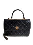 A Chanel Trendy CC in Black quilted leather with Gold Hardware, can be carried either in the hand