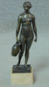 A bronze of a standing Classical female figure with water pitcher on square marble base. H.33cm