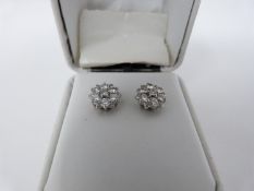 A pair of 18 carat white gold and diamond floral stud earrings set with fourteen round brilliant cut