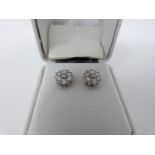 A pair of 18 carat white gold and diamond floral stud earrings set with fourteen round brilliant cut