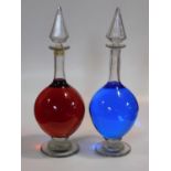 A large pair of 19th century clear blown glass chemist's shop window display carboys with original