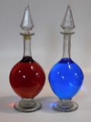 A large pair of 19th century clear blown glass chemist's shop window display carboys with original