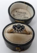A vintage three stone sapphire and diamond ring in an antique leather effect ring box. Set with