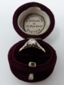 A vintage 18 carat yellow gold and platinum solitaire ring in a velvet antique ring box. Set with