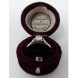 A vintage 18 carat yellow gold and platinum solitaire ring in a velvet antique ring box. Set with