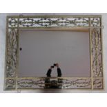 A large contemporary gilt metal overmantle or wall mirror the central rectangular plate surrounded