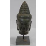 A Southeast Asian carved hardstone head of Vishnu with serene face, open eyes, elongated earlobes,