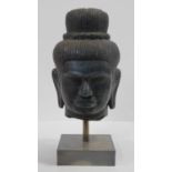 A Southeast Asian carved hardstone head of Vishnu with serene face, open eyes, elongated earlobes,