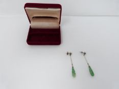 A pair of Art Deco style carved jade, diamond and white metal and 9ct gold drop earrings. The