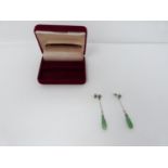 A pair of Art Deco style carved jade, diamond and white metal and 9ct gold drop earrings. The