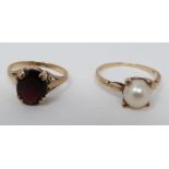 Two 9ct yellow gold dress rings. One set with a garnet with an approximate weight of 2.57 carats,