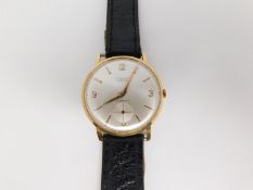 A Gentleman's Longines wristwatch in 18ct gold, the cream dial having gilt batons and alpha hands,