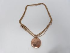 A Victorian 9 ct yellow gold watch chain and engraved rose gold locket. The chain has a secure