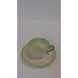 A Belleek 2nd period Irish porcelain waterlilly form tea cup and saucer with pale green detailing to