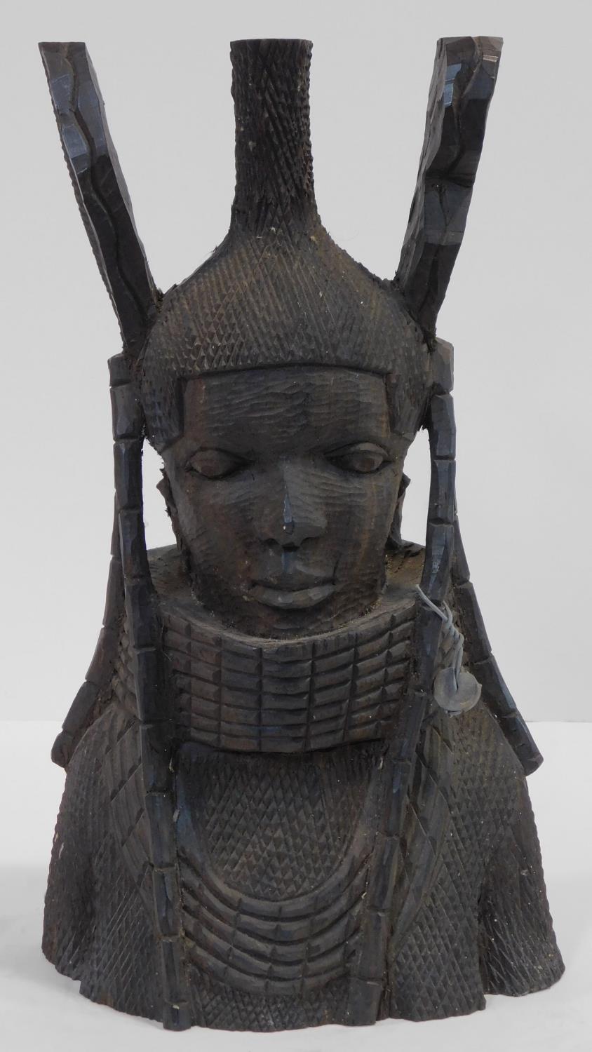 A Nigerian Benin carved wooden bust of a female warrior with neck rings and tribal headress. H.36cm