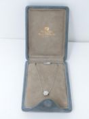 A suede cased 18 carat white gold and diamond floral pendant and chain by Mappin & Webb. Set with