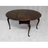A mid Georgian Irish mahogany circular drop flap dining table with gateleg action on carved cabriole