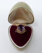 An antique 9 ct yellow gold and amethyst dress ring in a heart shaped vintage ring box. Set with