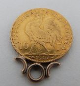 A 1907 French 10 Franc gold coin mounted pendant. One side with a rooster and the other with a